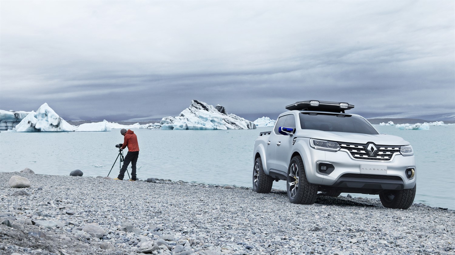 A man standing and clicking picture next to his Renault ALASKAN concept car