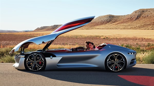A couple sitting inside Renault TREZOR concept car with sliding roof door open